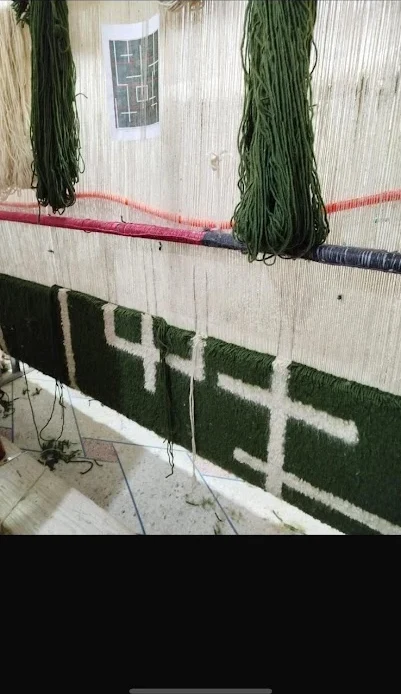 Vertical loom in the Khenifra workshop with a design card pinned above