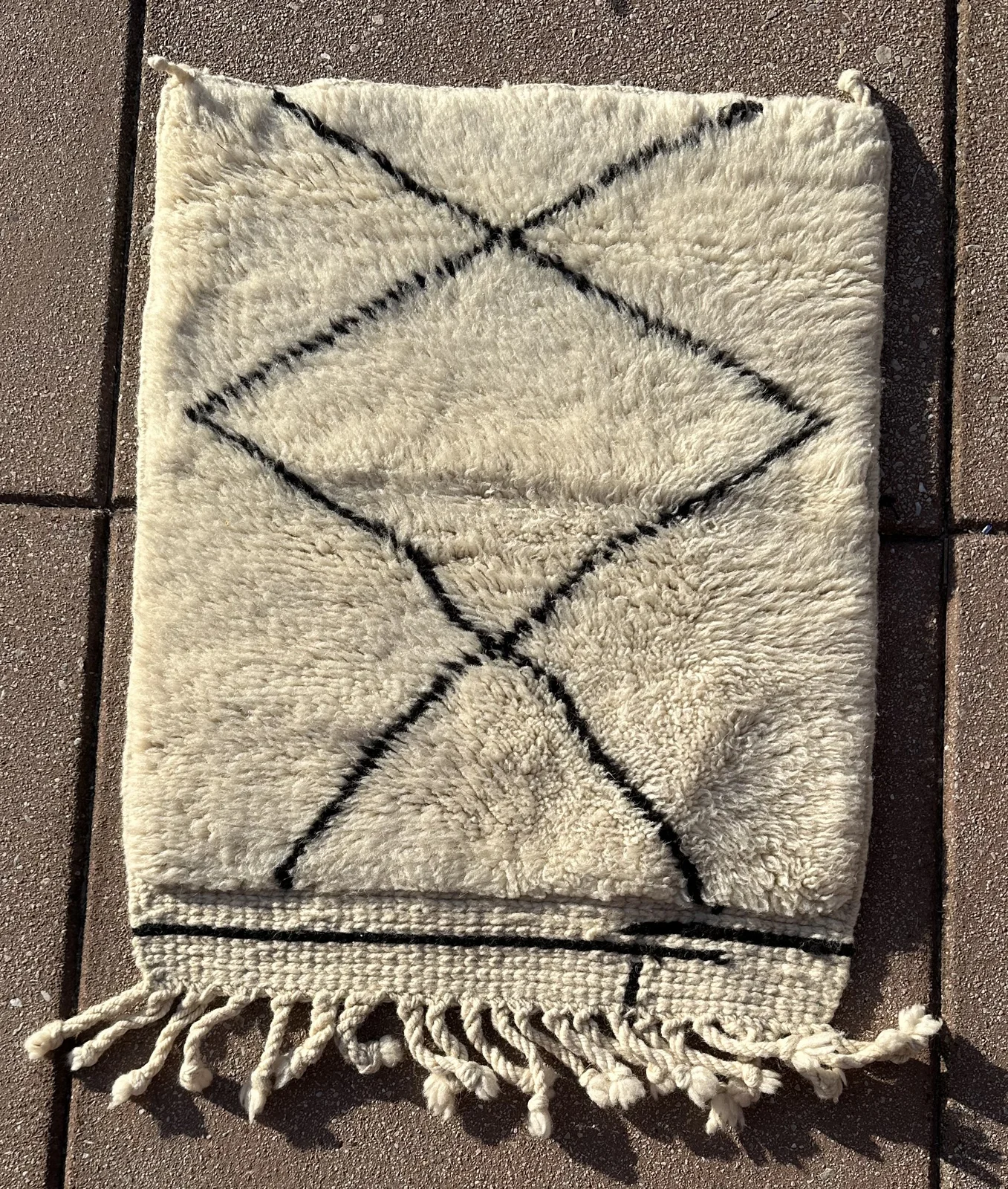 A full Mrirt diamond rug sized to catch every seat in a living room