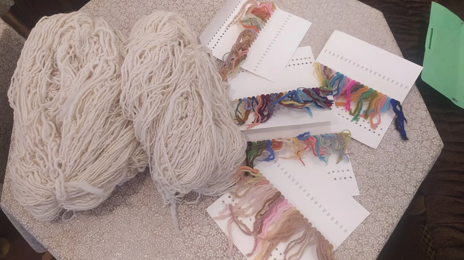 Woolmark-certified fleece samples pinned to color cards in our workshop